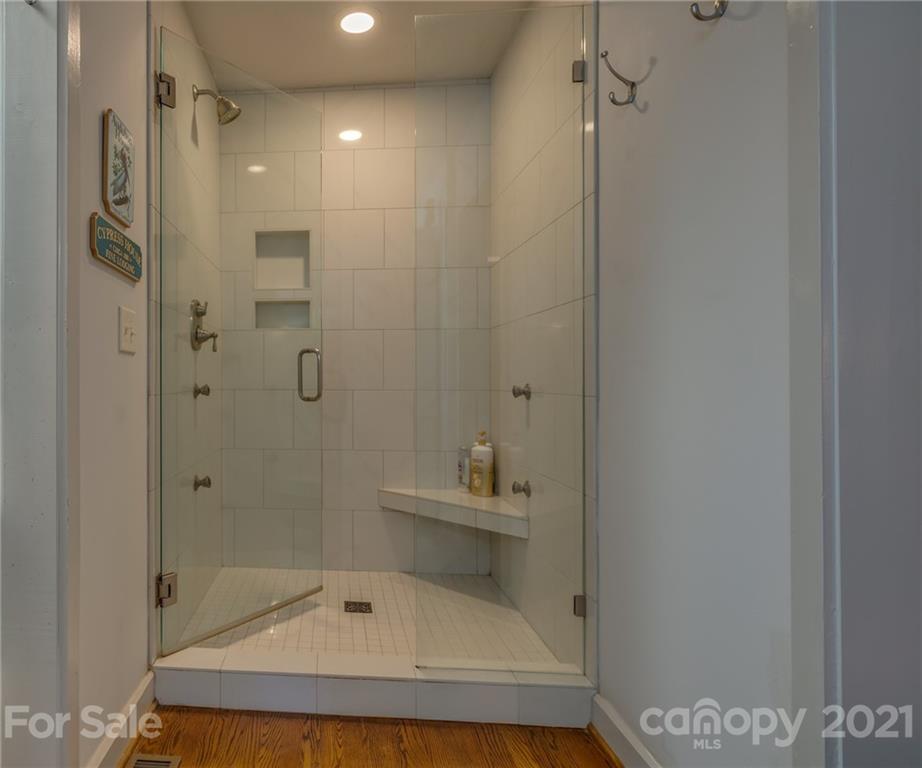 811 Hunting Country Road Tryon, NC 28782 - Photo 23 of 40 a bathroom with a granite countertop shower and a sink