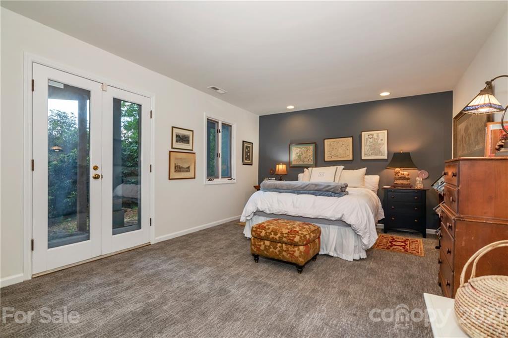 811 Hunting Country Road Tryon, NC 28782 - Photo 25 of 40 a bed room with a bed and a mirror