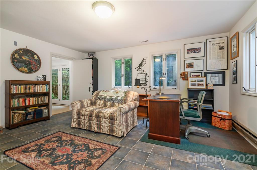 811 Hunting Country Road Tryon, NC 28782 - Photo 28 of 40 a living room with furniture and a book shelf