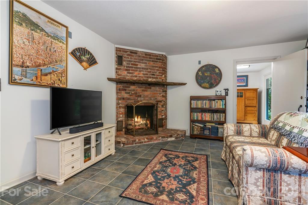 811 Hunting Country Road Tryon, NC 28782 - Photo 29 of 40 a living room with furniture and a flat screen tv