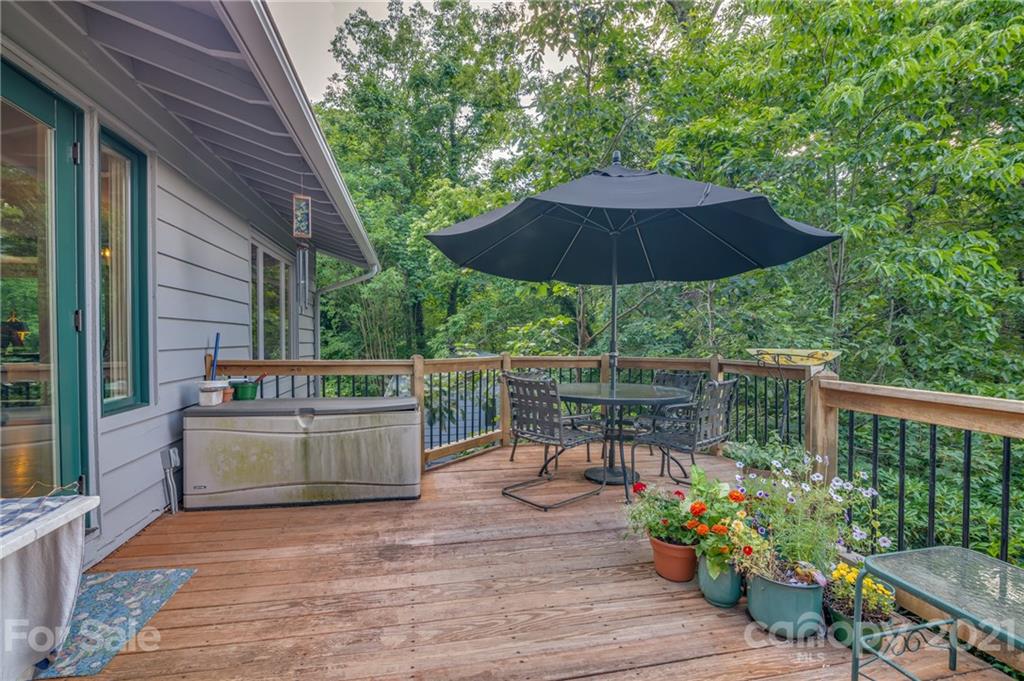 811 Hunting Country Road Tryon, NC 28782 - Photo 34 of 40 a view of a chair and tables under an umbrella