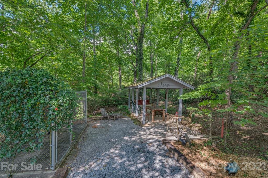 811 Hunting Country Road Tryon, NC 28782 - Photo 38 of 40 a backyard of a house with lots of trees