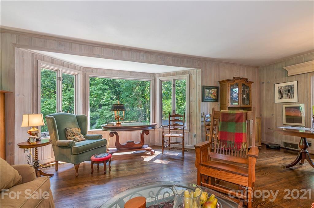 811 Hunting Country Road Tryon, NC 28782 - Photo 8 of 40 a living room with furniture and a floor to ceiling window
