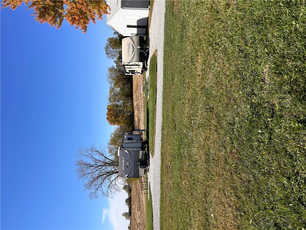 2086 Scheyhing Road Lewisburg, OH 45338 - Photo 21 of 29 This expansive lot features a gravel driveway and lush green lawn, ideal for outdoor living.