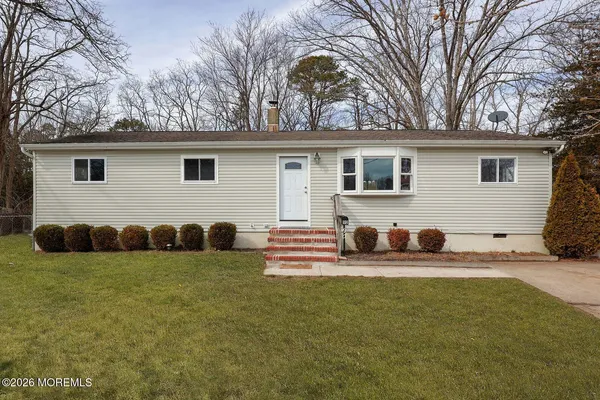 a view of a house with a yard and garage