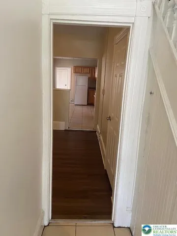 a view of a hallway with wooden floor and entryway