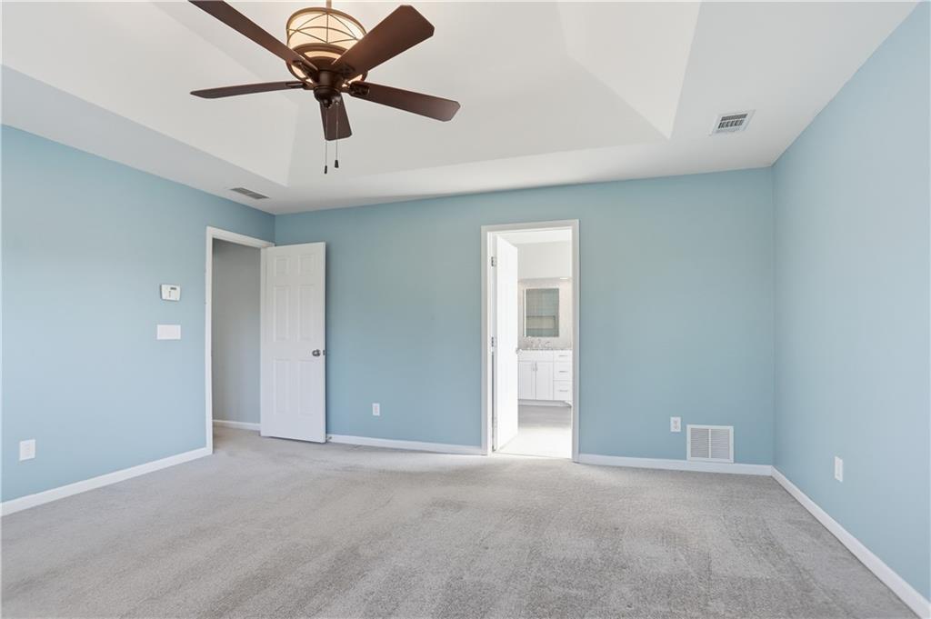 7770 Llangollen Way Cumming, GA 30041 - Photo 29 of 44 an empty room with a ceiling fan and carpet