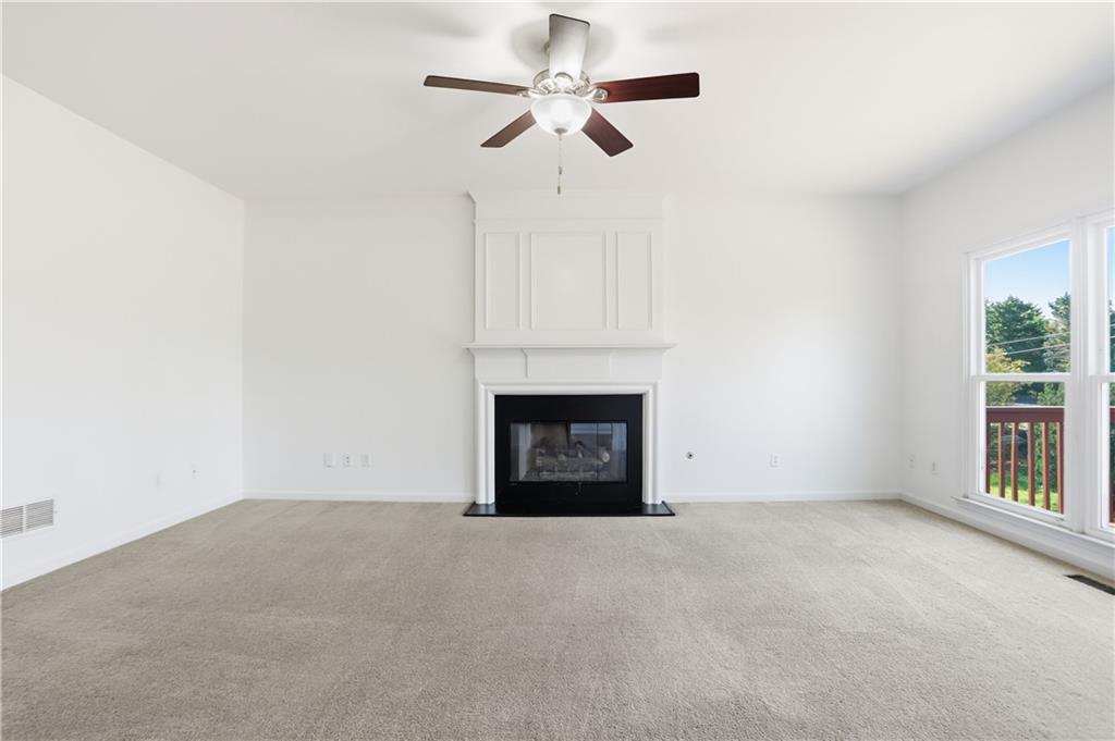 7770 Llangollen Way Cumming, GA 30041 - Photo 3 of 44 a view of an empty room with a fireplace