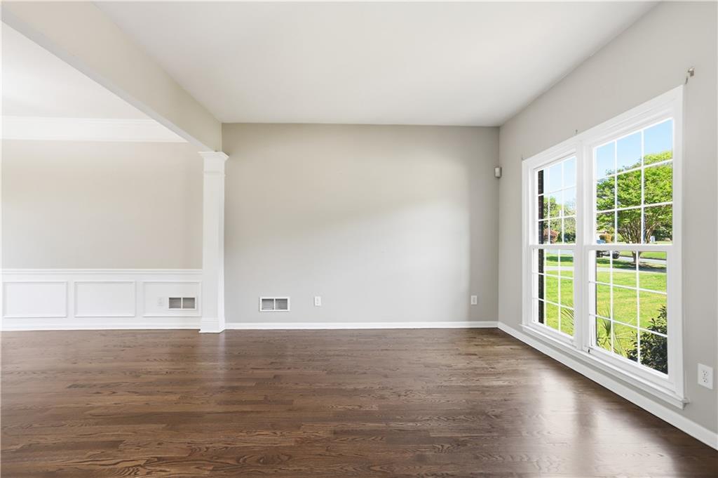7770 Llangollen Way Cumming, GA 30041 - Photo 8 of 44 a view of lot of room with window and wooden floor