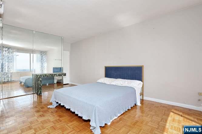 6 Horizon Road, Unit 2405 Fort Lee, NJ 07024 - Photo 19 of 42 a bedroom with a bed and couch