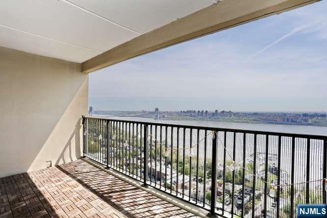 6 Horizon Road, Unit 2405 Fort Lee, NJ 07024 - Photo 2 of 42 a balcony with wooden floor