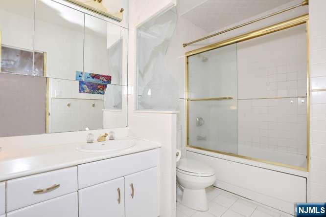 6 Horizon Road, Unit 2405 Fort Lee, NJ 07024 - Photo 23 of 42 a bathroom with a sink toilet and shower
