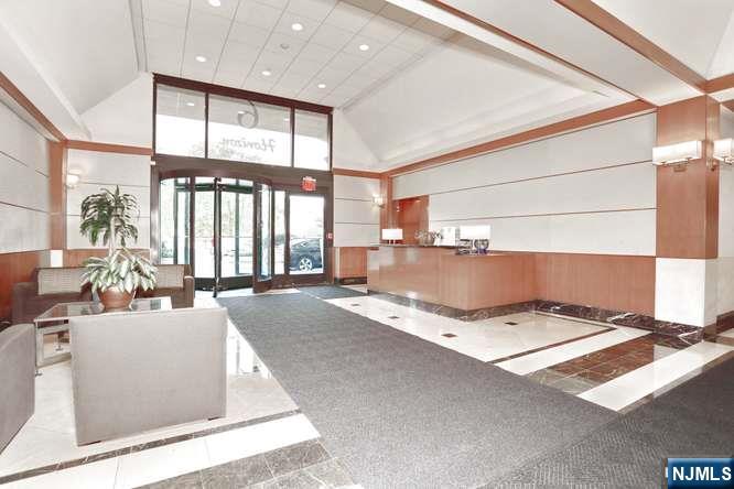 6 Horizon Road, Unit 2405 Fort Lee, NJ 07024 - Photo 38 of 42 a living room with patio furniture and a open kitchen view