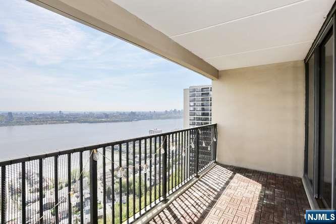 6 Horizon Road, Unit 2405 Fort Lee, NJ 07024 - Photo 4 of 42 a balcony with wooden floor and lake view