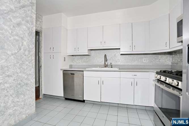 6 Horizon Road, Unit 2405 Fort Lee, NJ 07024 - Photo 6 of 42 a kitchen with white cabinets