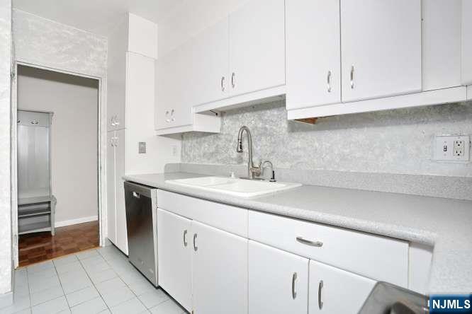 6 Horizon Road, Unit 2405 Fort Lee, NJ 07024 - Photo 8 of 42 a kitchen with stainless steel appliances granite countertop white cabinets and a sink