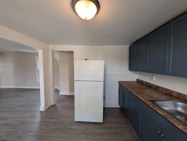 a kitchen with a refrigerator and a sink