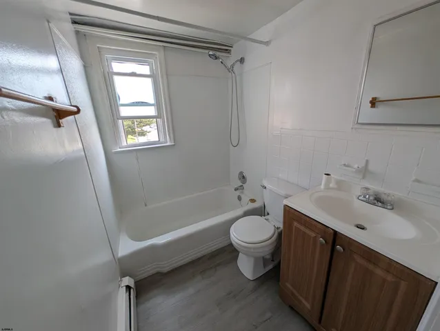 a bathroom with a sink toilet bathtub and vanity