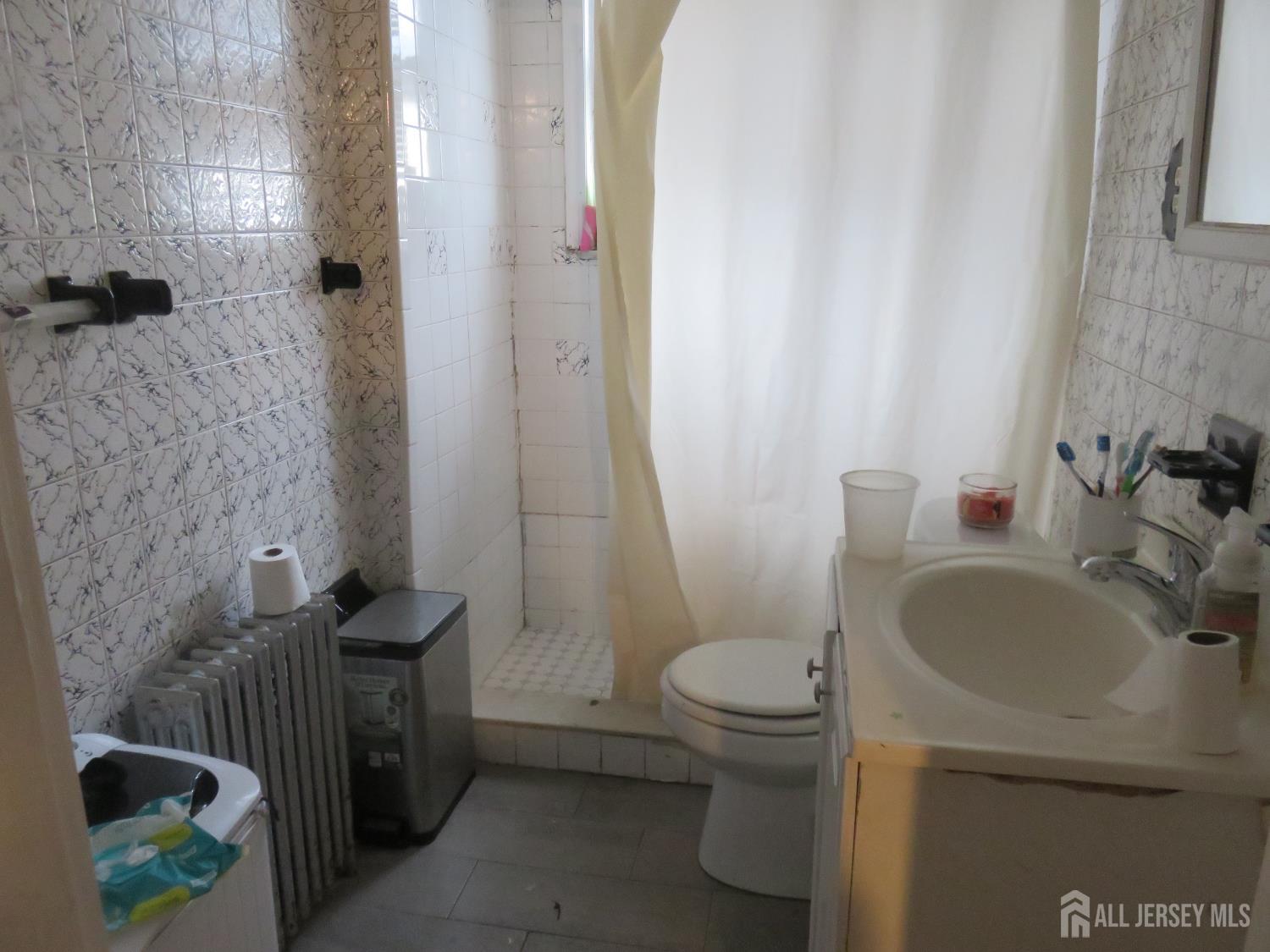 715 State Street Perth Amboy, NJ 08861 - Photo 11 of 13 a bathroom with a sink and toilet