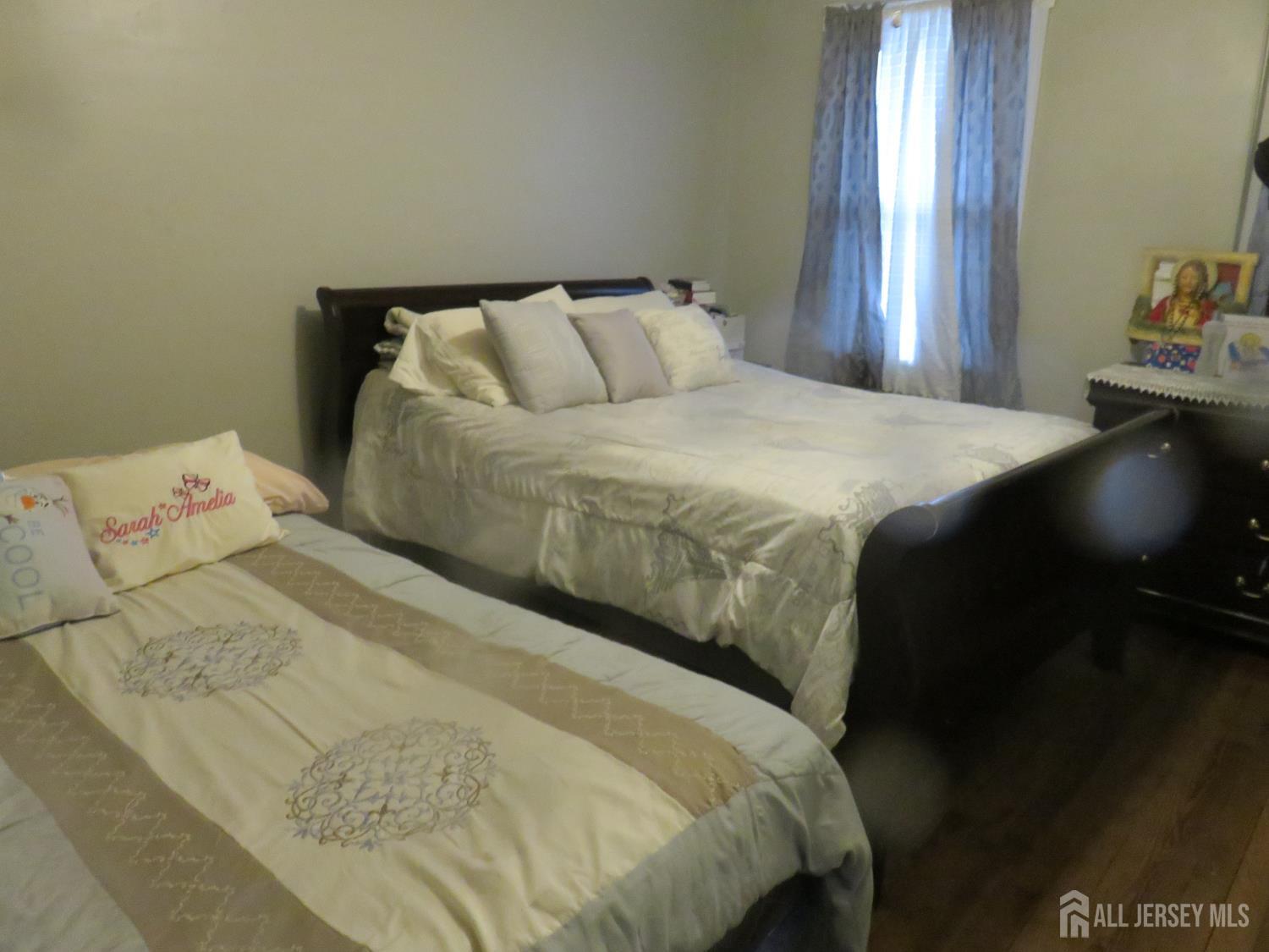 715 State Street Perth Amboy, NJ 08861 - Photo 2 of 13 a bedroom with a bed and window