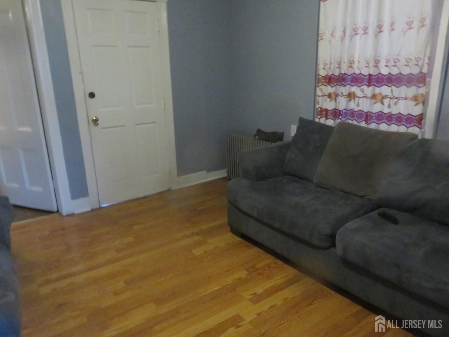 715 State Street Perth Amboy, NJ 08861 - Photo 3 of 13 a living room with furniture and a rug