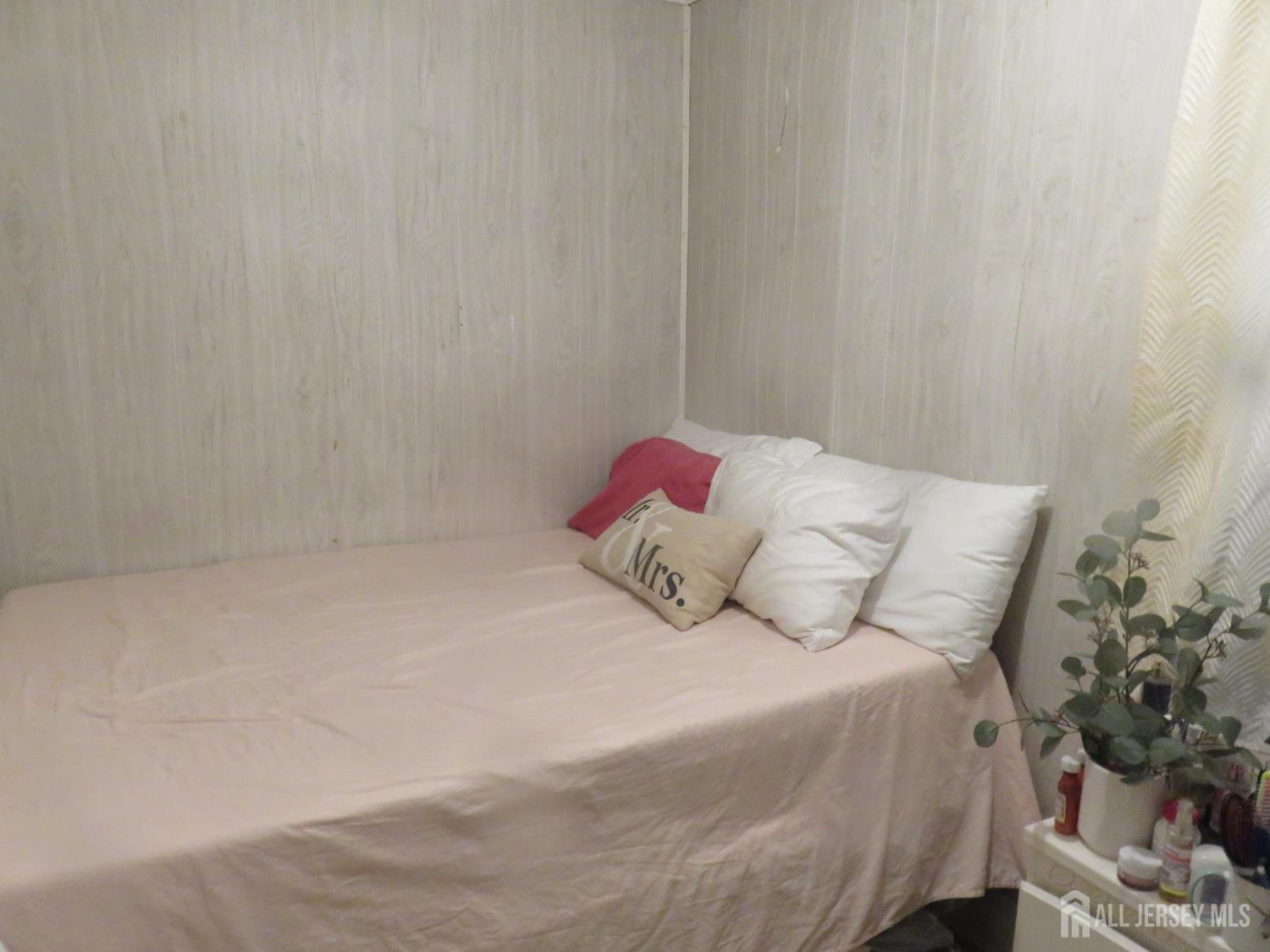 715 State Street Perth Amboy, NJ 08861 - Photo 4 of 13 a bedroom with a bed and a plant