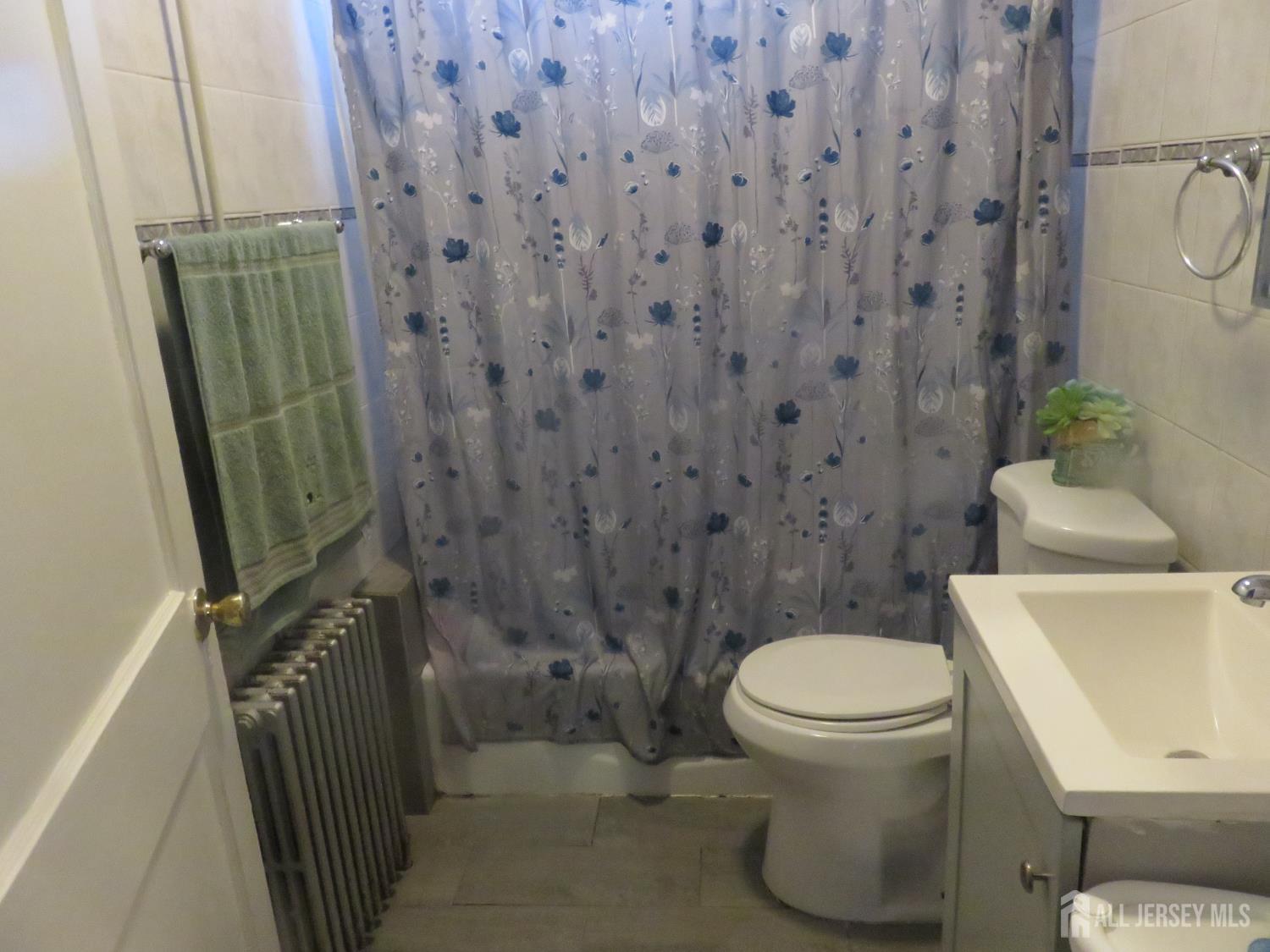 715 State Street Perth Amboy, NJ 08861 - Photo 6 of 13 a bathroom with a toilet and a shower