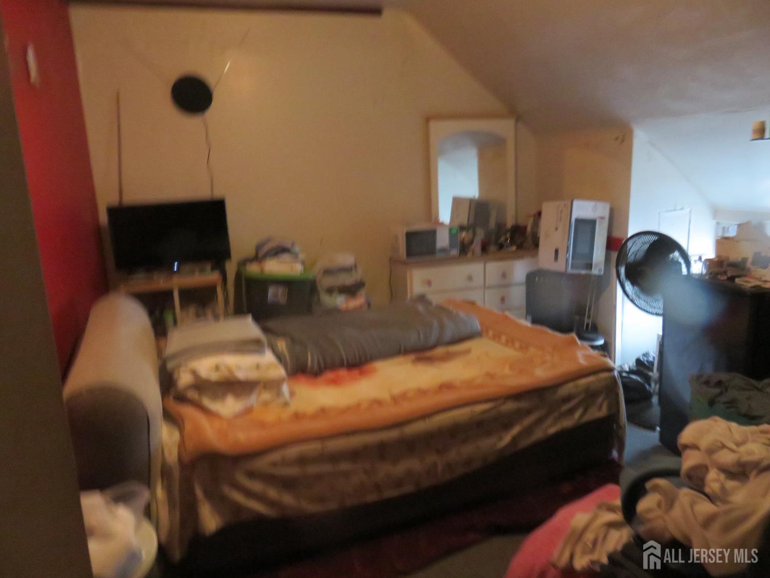 715 State Street Perth Amboy, NJ 08861 - Photo 8 of 13 a bedroom with bed and a window