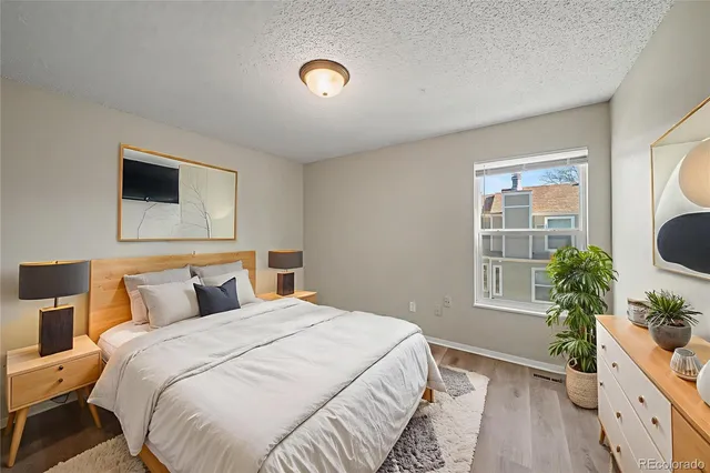 a bedroom with a bed and a potted plant