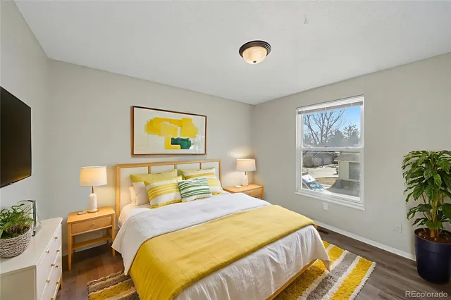 a bedroom with a bed and a potted plant