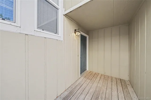 a view of a room with wooden floor and entryway