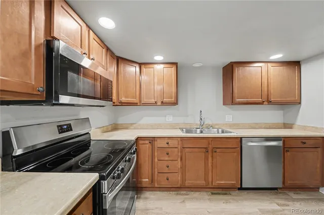 a kitchen with a sink stove and cabinets