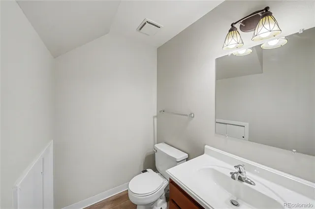 a white toilet sitting next to a bathroom sink