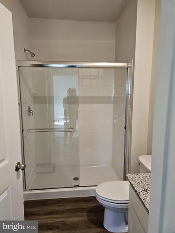 a view of a kitchen with refrigerator and a sink