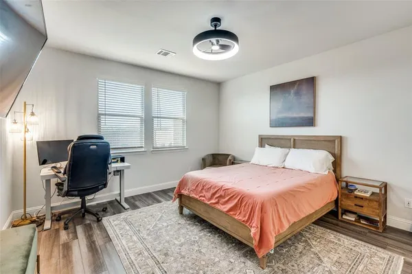 a bedroom with a bed and a chair