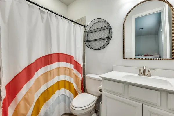 a bathroom with a sink a mirror a toilet and a mirror