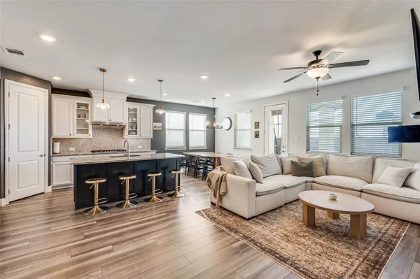 a living room with furniture and kitchen view