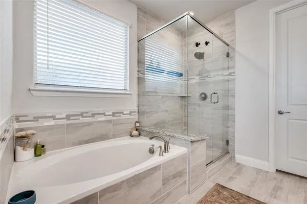 a bathroom with a bathtub and a shower