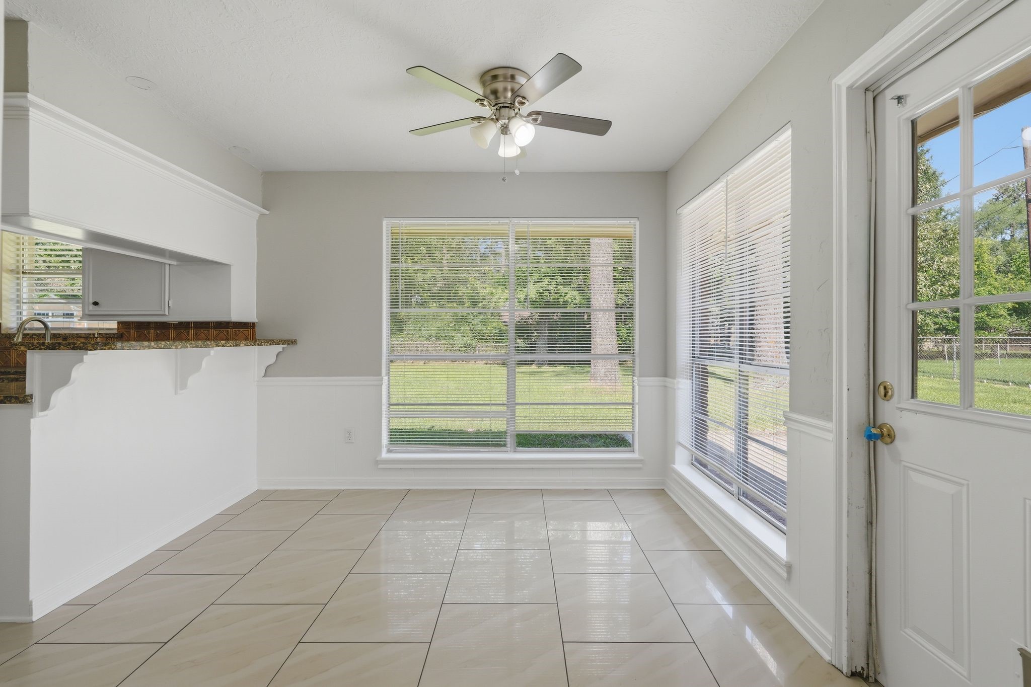 25611 Timberlane Drive Spring, TX 77386 - Photo 16 of 38 a view of a kitchen with a stove cabinets and a floor to ceiling window