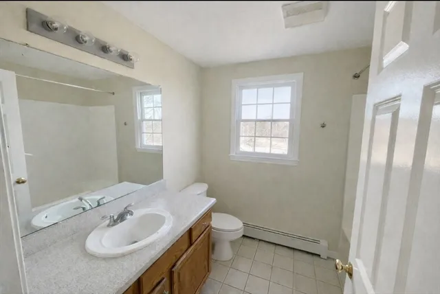 a bathroom with a sink toilet and mirror