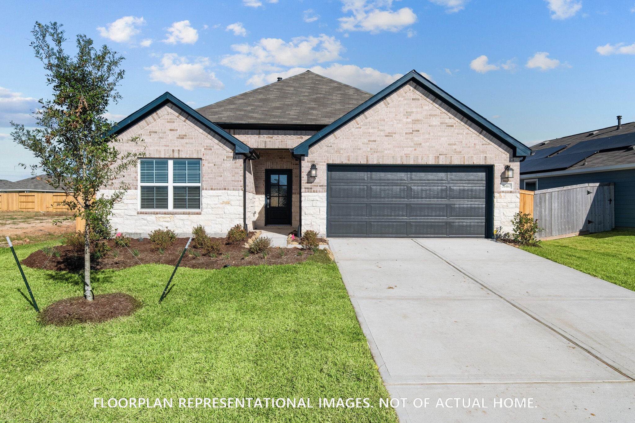 2119 Lone Bronco Boulevard Rosenberg, TX 77471 - Photo 4 of 12 a front view of a house with a yard and garage