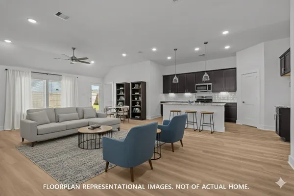 a kitchen with a sink a microwave and cabinets
