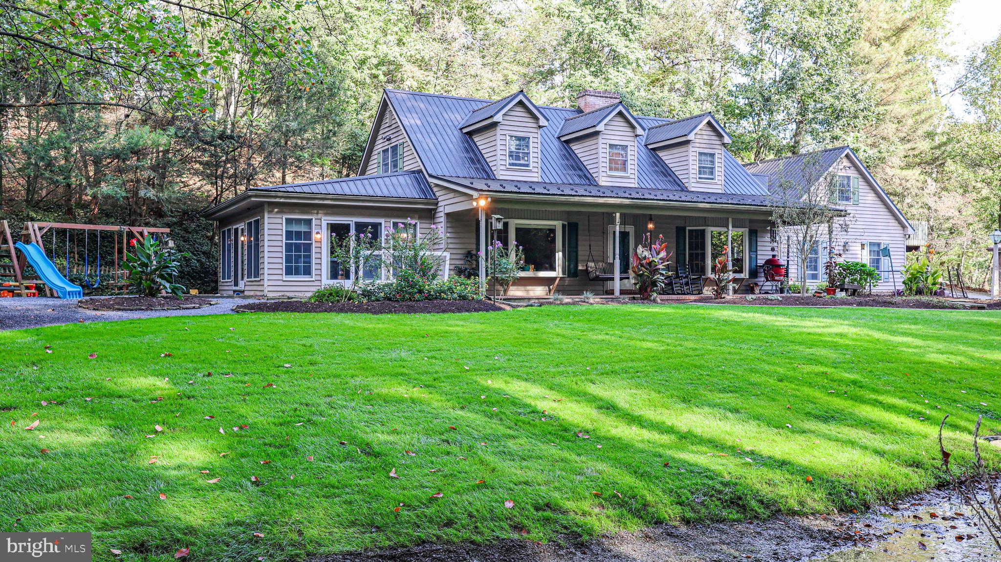 a front view of a house with garden and a patio