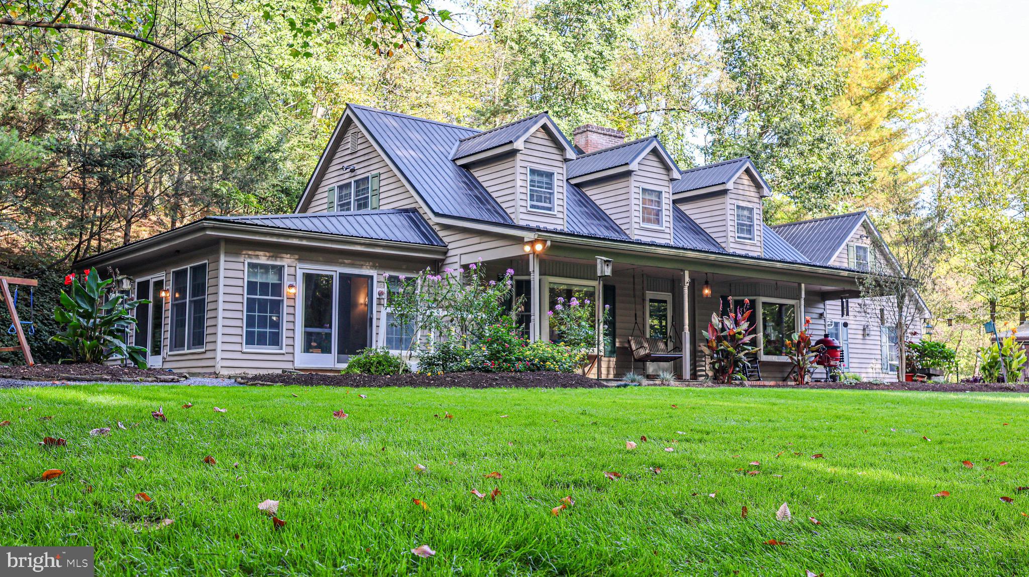 240 Evans Road Lititz, PA 17543 - Photo 50 of 77 a front view of a house with garden and porch