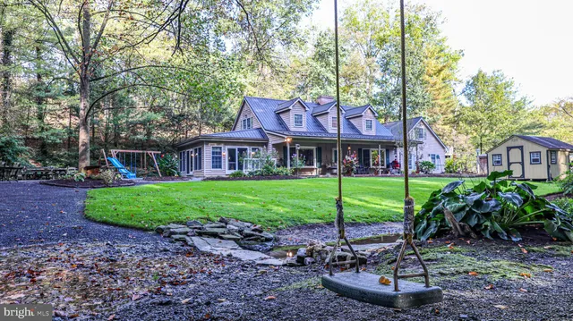 a view of a brick house with a yard and plants