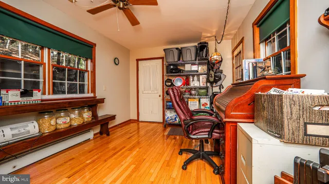 a living room with furniture and a book shelf