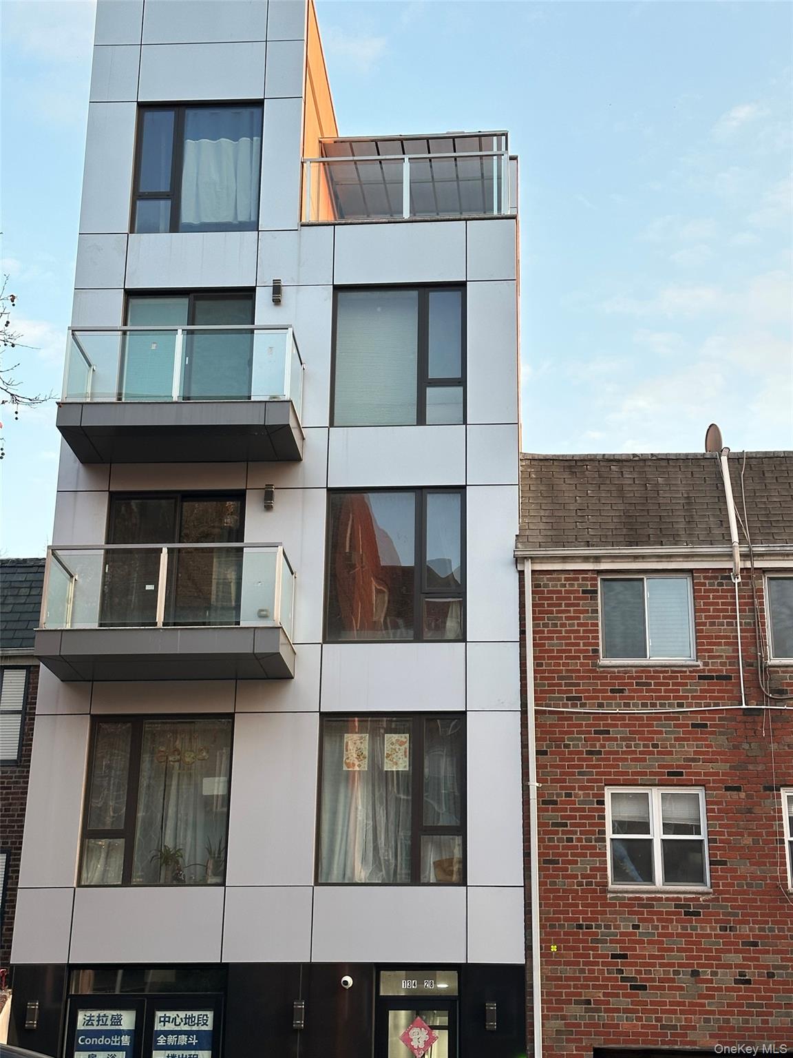 134-28 Blossom Avenue, Unit 2B Queens, NY 11355 - Photo 1 of 2 a building with multiple window