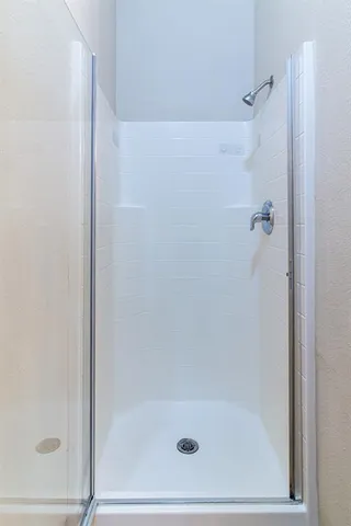 a bathroom with a glass shower door