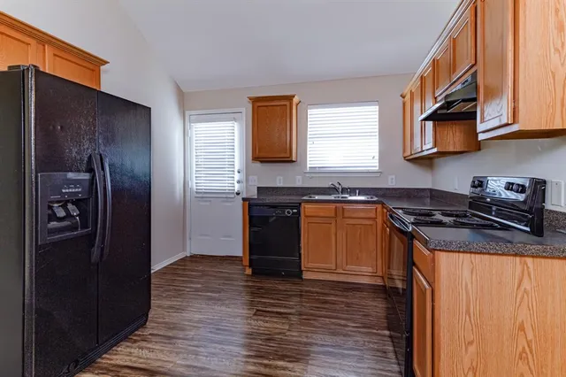 a kitchen with stainless steel appliances granite countertop a stove and a refrigerator