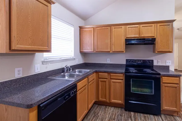 a kitchen with a sink stove and cabinets